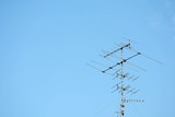 old televisions antenna on blue sky