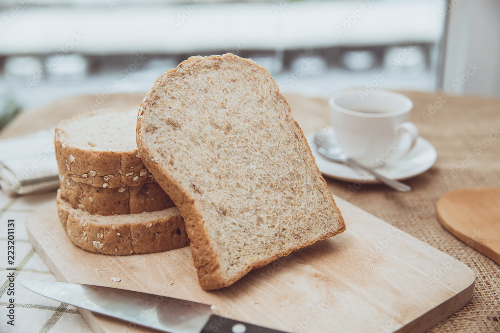 whole grain bread on wooden table morning meal with coffee vintage color tone