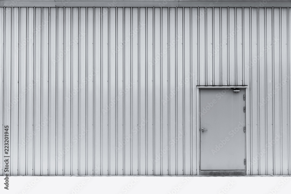 Industrial door on aluminium wall factory warehouse. Industrial door on aluminium wall factory warehouse.