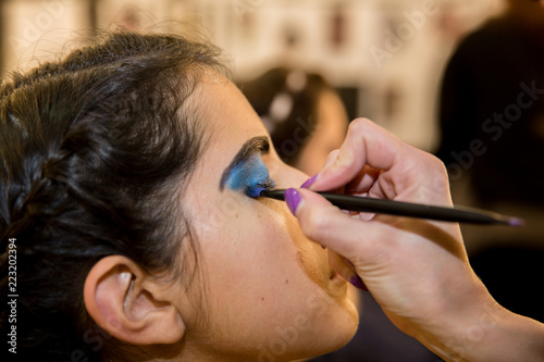 Young women doing makeup , old-fashioned. Backstage.