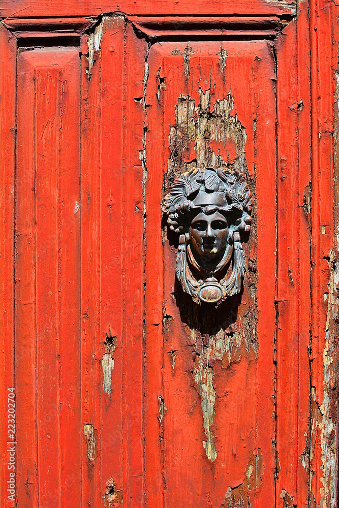 The old knocker at the red door