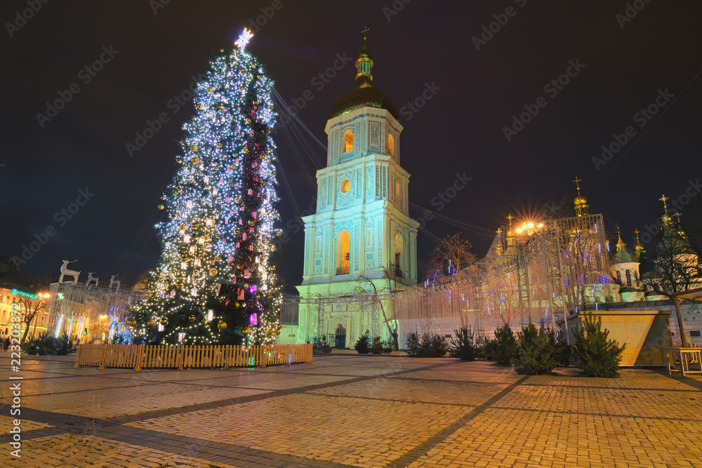 KYIV, UKRAINE - JANUARY 07, 2018: Beautiful decorated main Kyiv's New Year tree. Christmas market in the early morning on Sophia Square in Kyiv, Ukraine