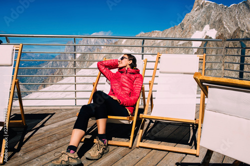 Tourist resting on Chaise Lounges, at observation deck Punta Helbronner, Italy