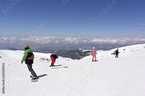 On the snow-capped peaks of the mountain Sierra Nevada skiers and snowboarders