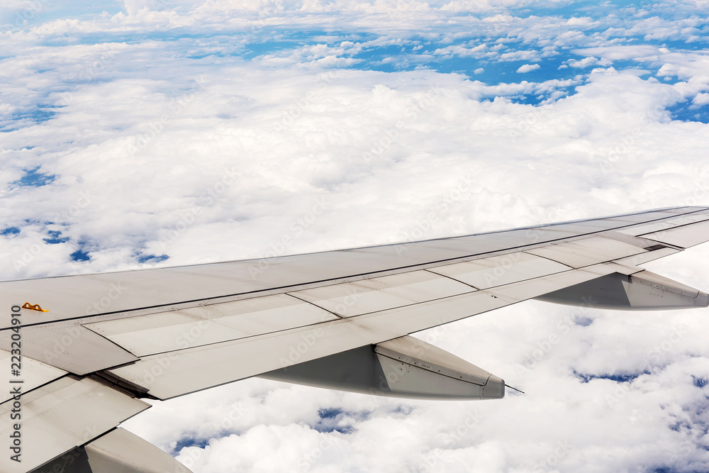Looking through window aircraft during flight in wing with a blue sky Looking through window aircraft during flight in wing with a blue sky