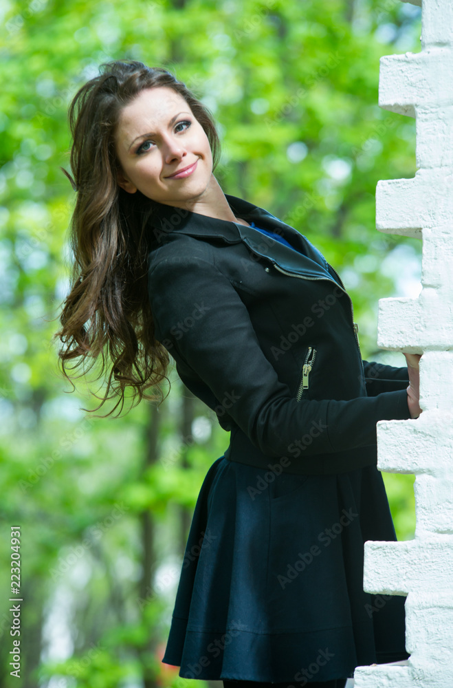 Fototapeta premium Beautiful young girl walking in spring Park