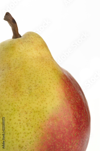 Yellow ripe pear on white background. Part of red-yellow pear.