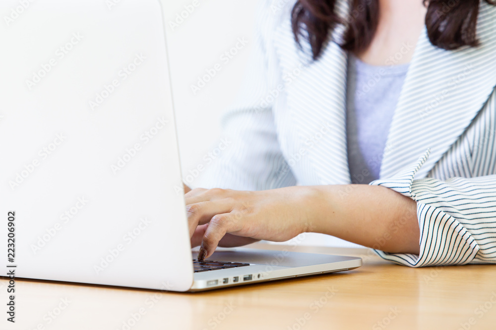 Smart young Asian business women age between 25-30 years old smiling and using a laptop computer close up. Concept of smart and confident women in business. Smart young Asian business women age between 25-30 years old smiling and using a laptop computer close up. Concept of smart and confident women in business.