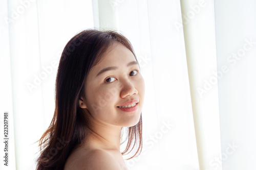 Portrait of beautiful Asian women in morning with natural lighting from window close up.