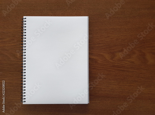 white notebook on wooden table