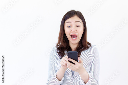Beautiful Asian business women age between 25-30 years old in the white suit  looking at her smartphone and laughing close up.  Drop white copy on the left side for text or other use.