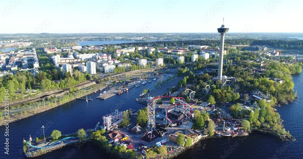 Beautiful aerial footage of amusement park
in Tampere city at summer. Camera moves forward.