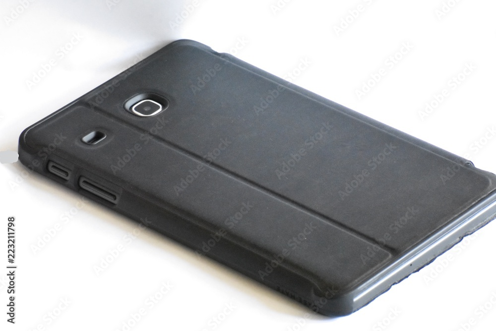 tablet isolated, in a black case, with camera lens on white background tablet isolated, in a black case, with camera lens on white background