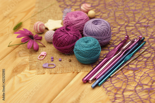 colorful yarn for knitting on a brown wooden table