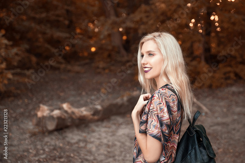 Young cheerful woman walking in nature