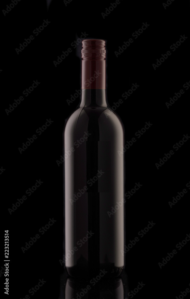 A bottle of red elite wine on a black background. Silhouette of a bottle of wine with a red stopper. A bottle of red elite wine on a black background. Silhouette of a bottle of wine with a red stopper.