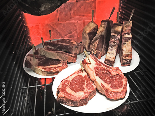 dry ageing ribeye steaks with extra long rib bones photo