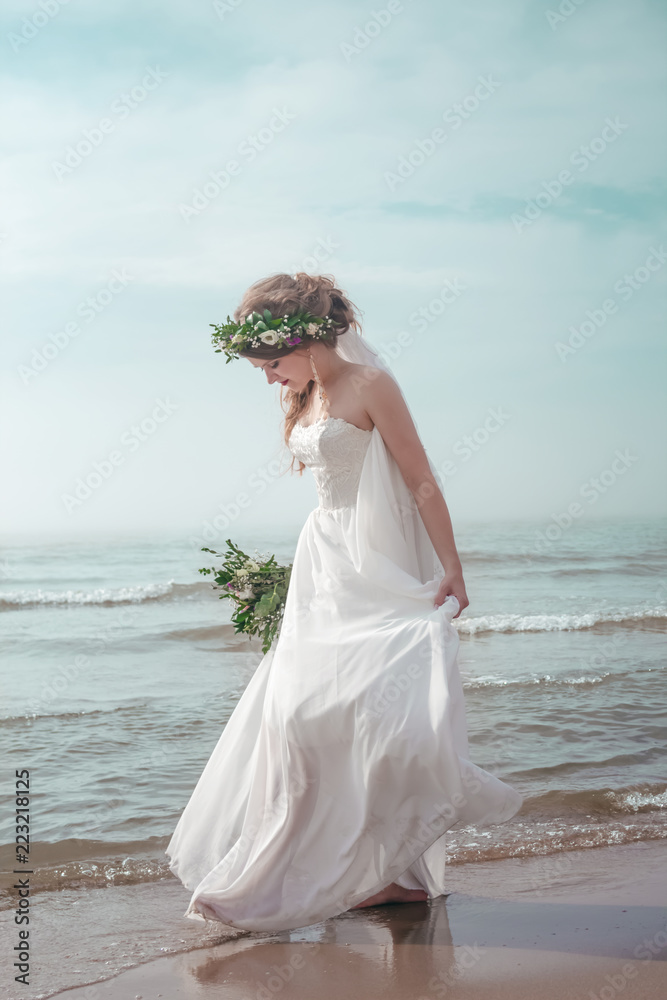 Bride on the beach with wedding bouqet soft copy space Bride on the beach with wedding bouqet soft copy space