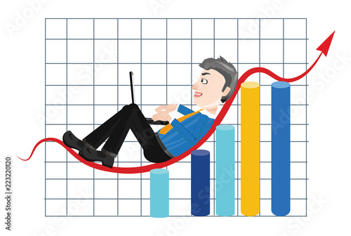 Satisfied businessman working on a laptop over a successful business graph chart