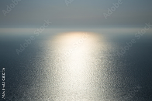 The magic of nature. Light on water. Gentle beautiful seascape in the Atlantic ocean with glowing solar path.