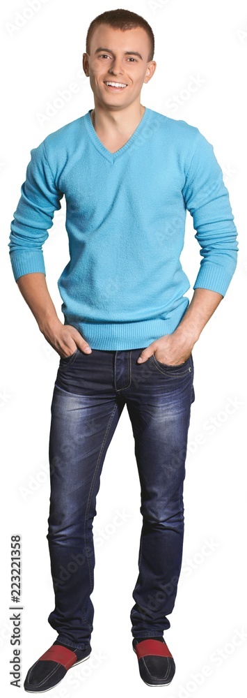 Smiling Young Man Standing with Hands in Pockets - Isolated Smiling Young Man Standing with Hands in Pockets - Isolated