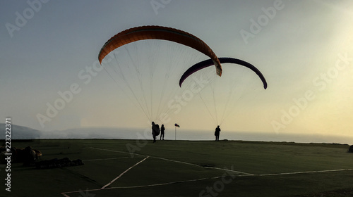 silhouette of paraglider at sunset