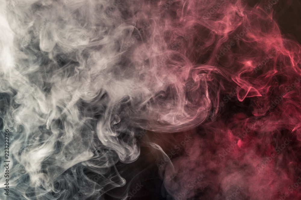 Colorful smoke on a black background of red and white colors. The concept of smoking. Beautiful textural background Colorful smoke on a black background of red and white colors. The concept of smoking. Beautiful textural background