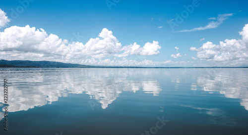 Beautiful tranquility of the calm, smooth water on the lake at El Golfete, in between Rio Dulce and Livingston in Guatemala