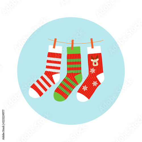 Knitted socks with a deer and a strip, red with green, hanging on a rope. Christmas Socks vector background. Various Christmas socks