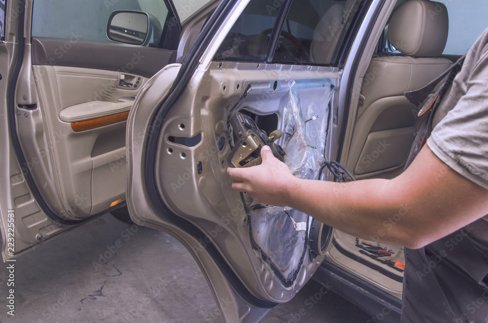 car mechanic repairs the door in the car