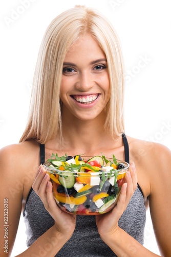 Woman in sportswear with salad, isolated