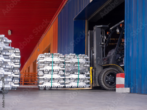 Photography Close up aluminium ingot in bundle handling by forklift in warehouse