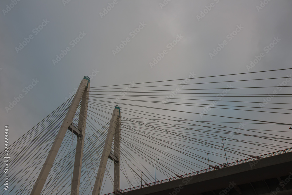 Fototapeta premium Cable stayed bridge on Neva river in of St. Petersburg at cloud autumn evening, Russia.
