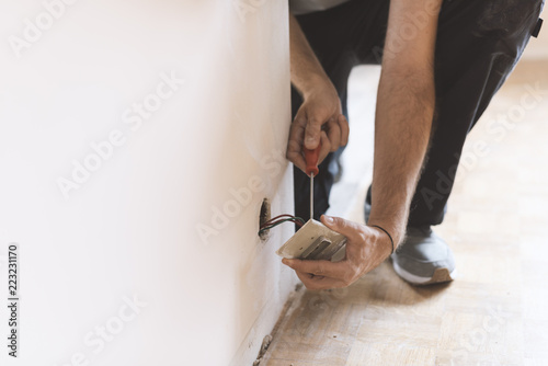 Professional electrician, installing sockets at home