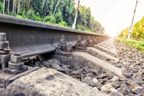 Old rust bolts for mounting rails on railroad track. Reliability of rail transport