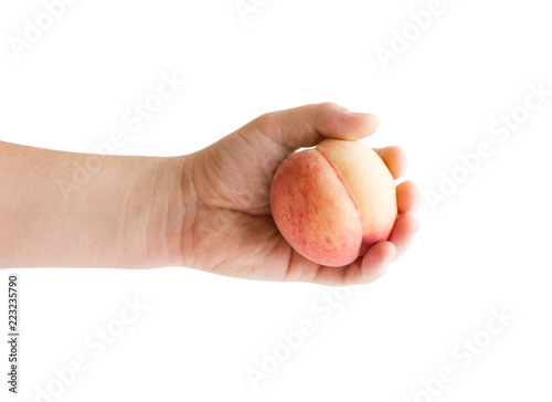 A peach in his hand. Ripe peach in a hand on a white background.
