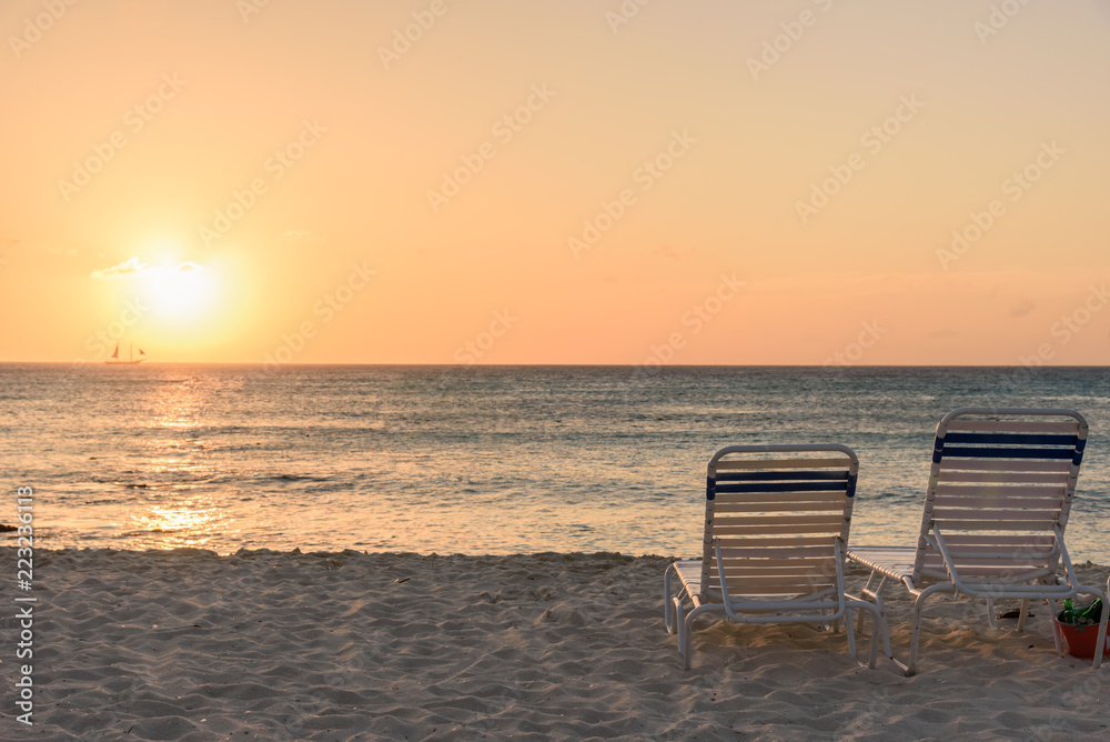 Sun bed on the beach at sunset