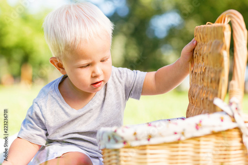 Magic basket. Little nice boy being attentive while opening a basket © zinkevych