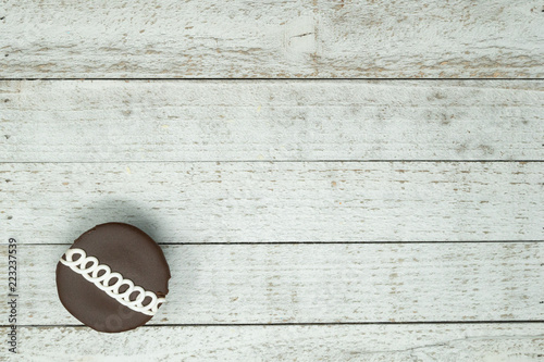 Photography Chocolate swirled decorated cupcake with blue napkin on wood background