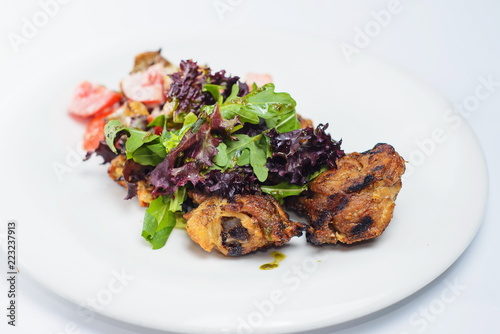 salad with chicken vegetables on a white plate