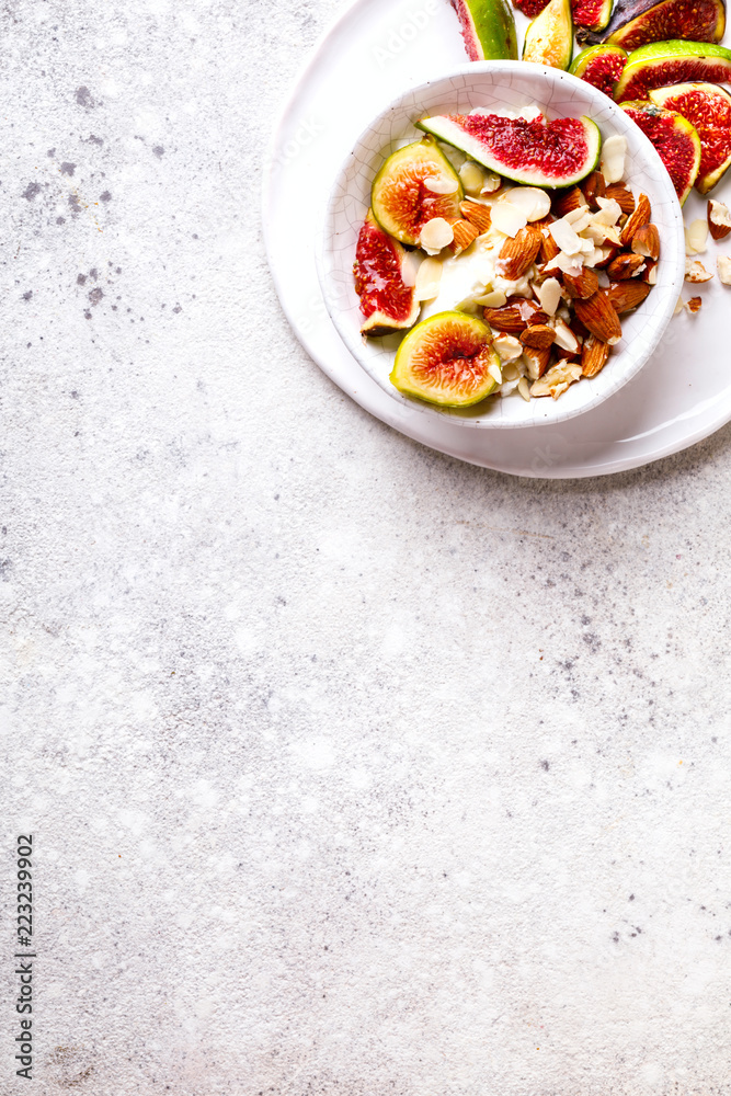 Yogurt Greek with figs Almond and Mead. Healthy Food Concept. Useful breakfast on the stone background.Diet Nutrition.Top View.Copy space for Text.
