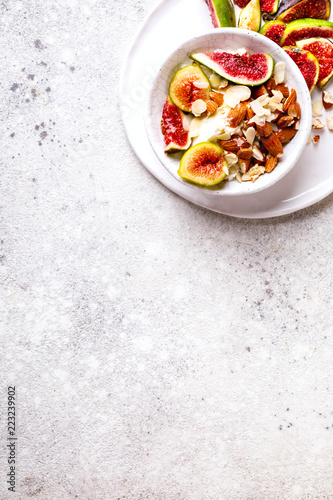 Yogurt Greek with figs Almond and Mead. Healthy Food Concept. Useful breakfast on the stone background.Diet Nutrition.Top View.Copy space for Text.