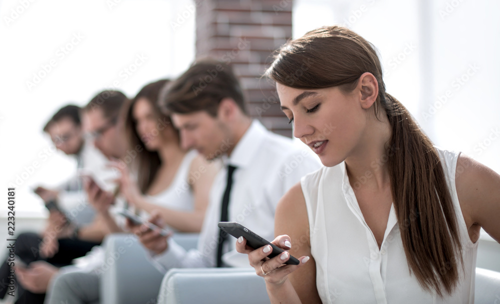 Fototapeta premium young employee looking at text message on smartphone