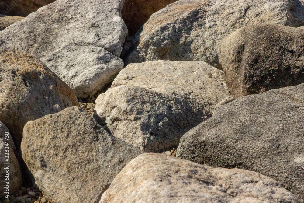Large rock natural building material retaining barrier Large rock natural building material retaining barrier