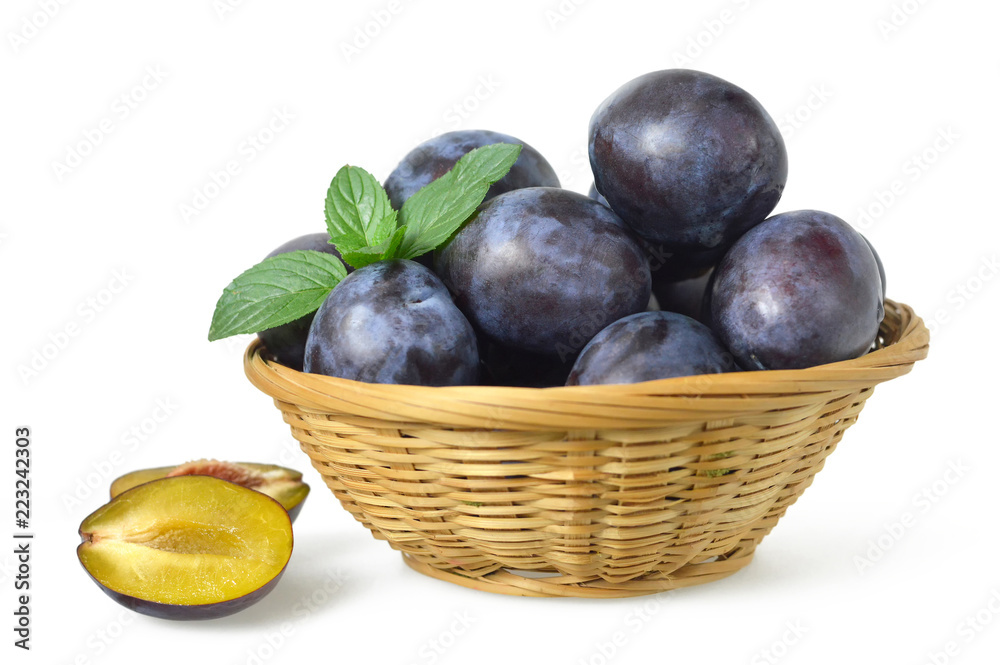Fresh plums in the basket isolated on white background