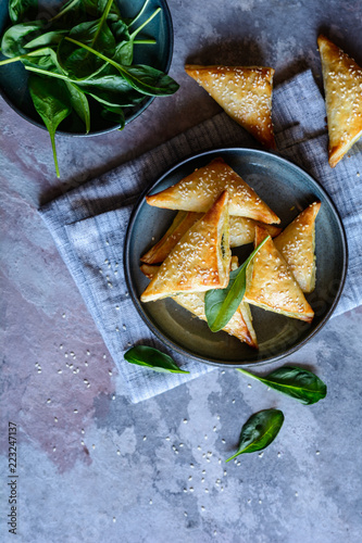 Spanakopita triangles stuffed with spinach and Feta cheese