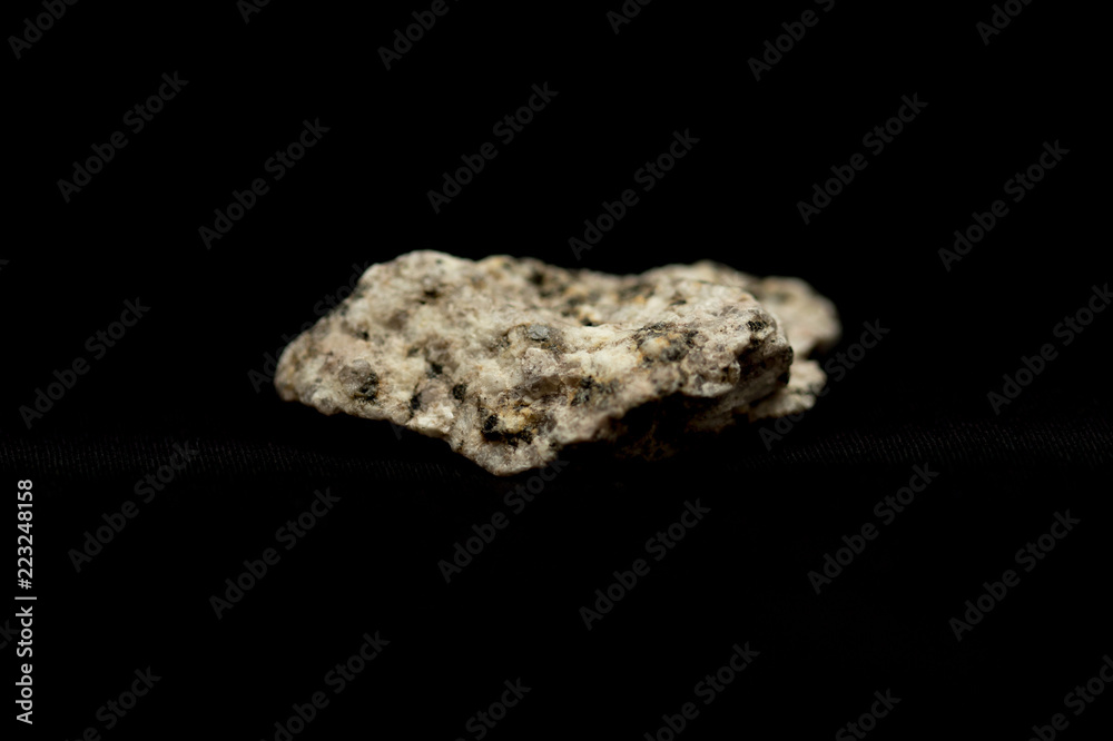Granite fragment on a black background Granite fragment on a black background