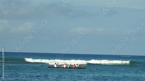 Canoes paddlers, surfers and standup paddle boards at Kaimana Beach in Honolulu, Hawaii photo