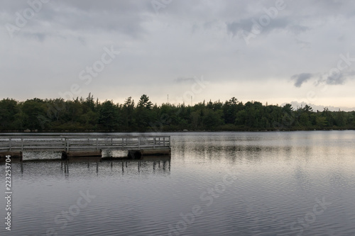 Wooden boardwalk lakeside, overcast sky, lewis lake, nova scotia, canada