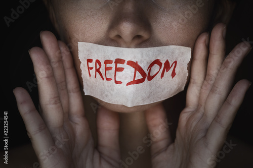 Fotografija Concept of freedom speech: mouth of a person is sealed with an adhesive tape, cl
